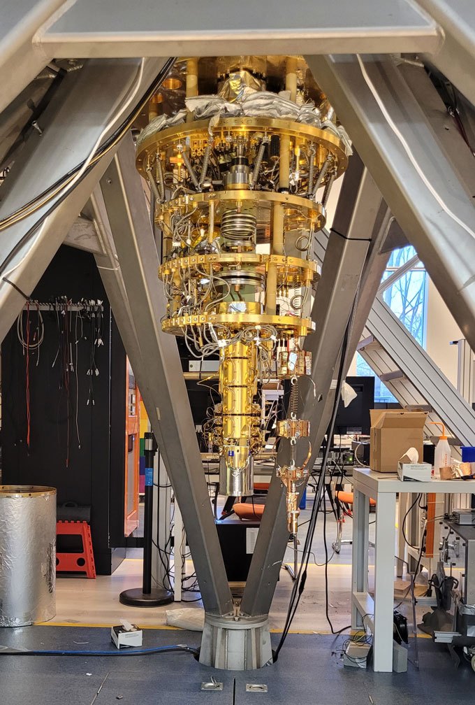 051625_ec_darkmattermagnet_inline An apparatus resembling a gold chandelier in a laboratory setup, designed to detect magnetic disturbances caused by dark matter