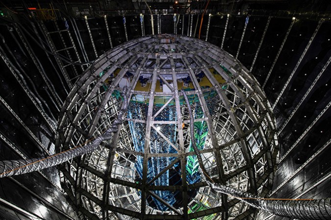 121624_ec_neutrino-detector_slide4 A spherical steel structure is shown inside of a large pit.